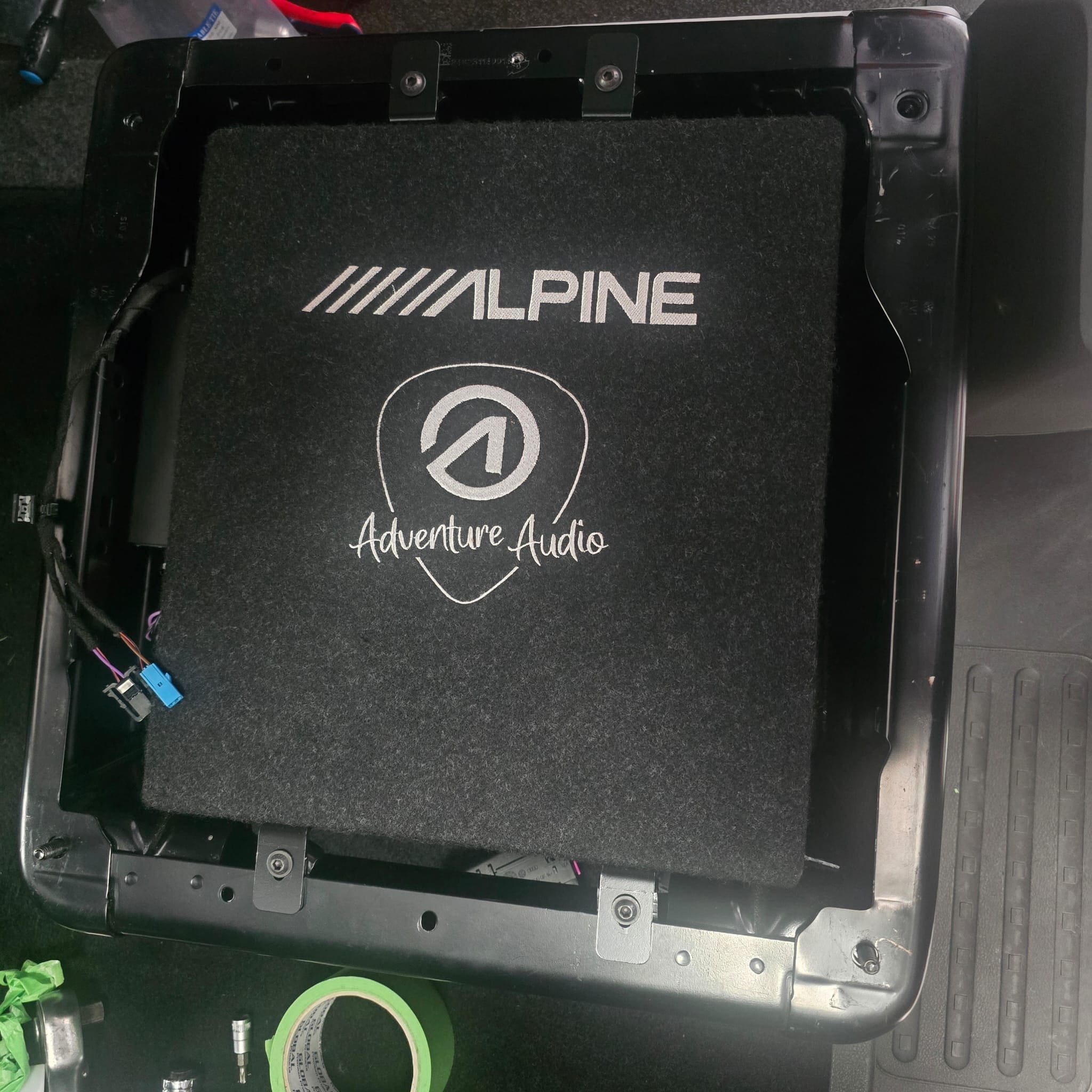 Under-seat Alpine bass system fitted with trims refitted for a clean OEM-style finish