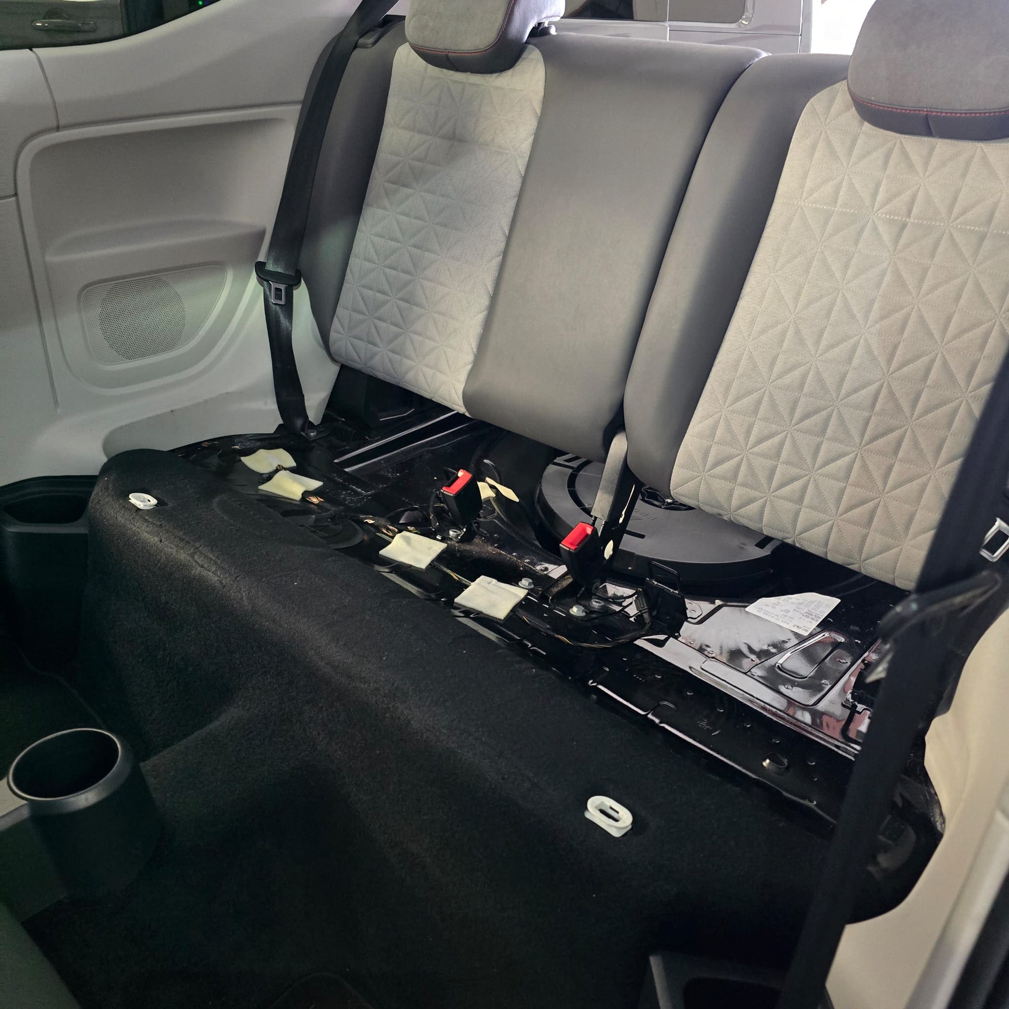 VW Up in the workshop after rear OEM parking sensor retrofit using a genuine VW optical sensor kit