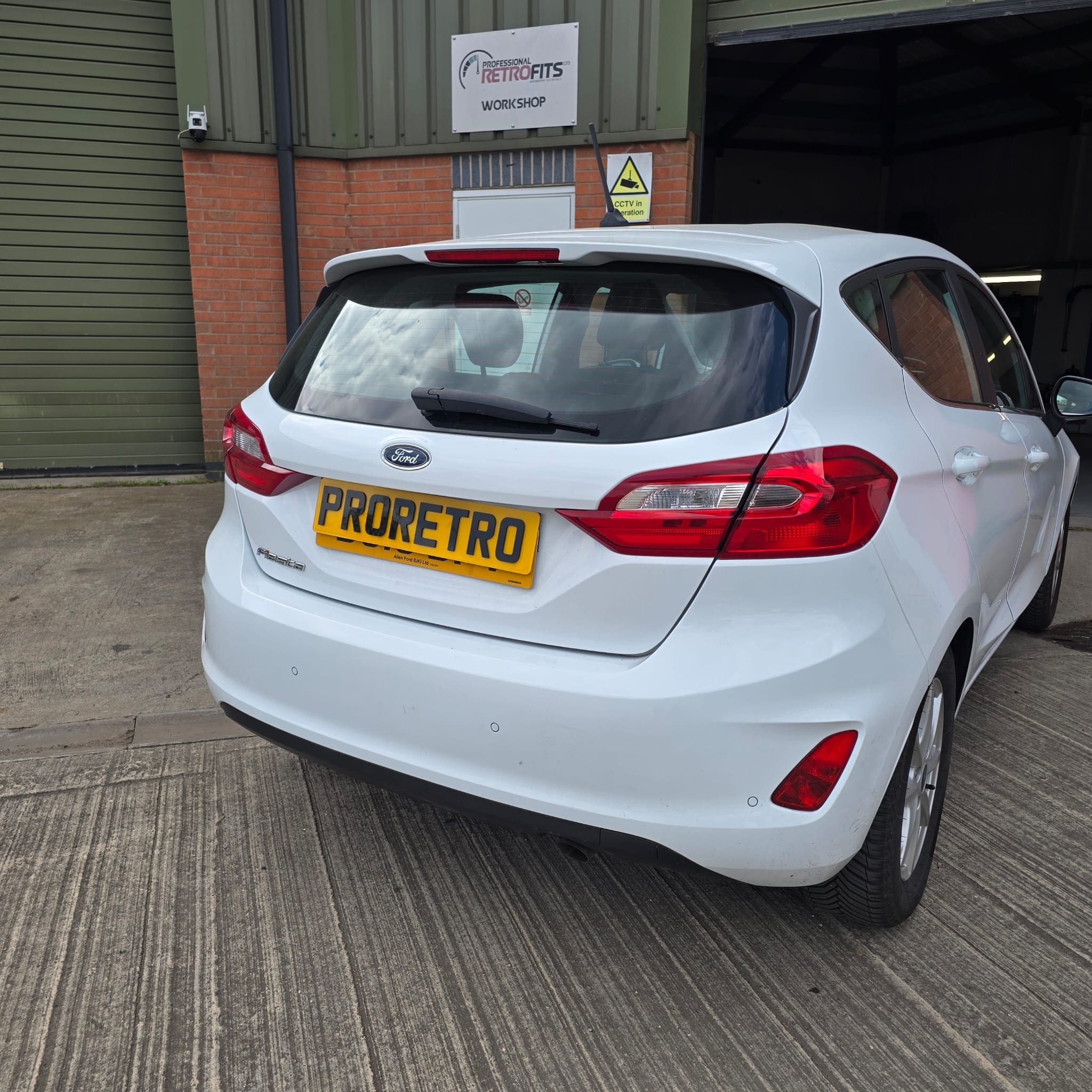 Rear bumper detail showing neat alignment of flush fit parking sensors on a Ford Fiesta