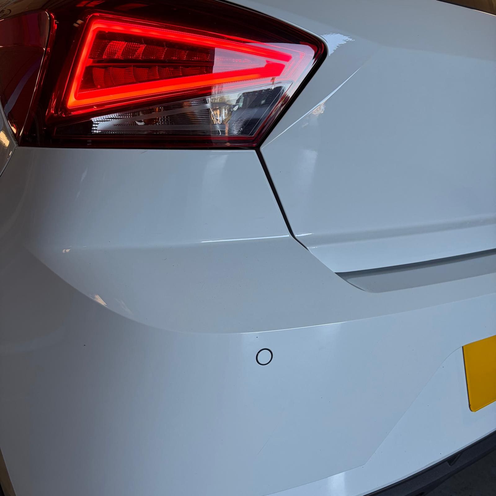 Rear bumper area of Seat Ibiza FR Mk3 showing OEM rear parking sensors after retrofit