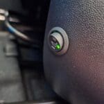 Aftermarket heated seat hi low switch installed in seat base trim
