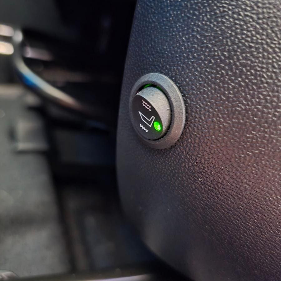 Aftermarket heated seat hi low switch installed in seat base trim