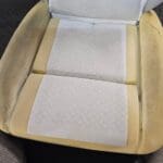 Vehicle seat with aftermarket heating pads installed under the upholstery